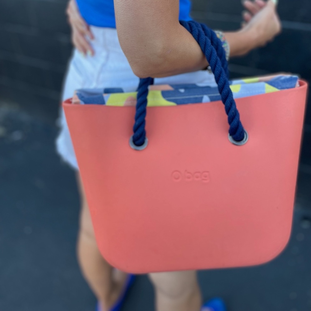 OBAG Tote: coral tote, dark blue handles and multicolor lining.